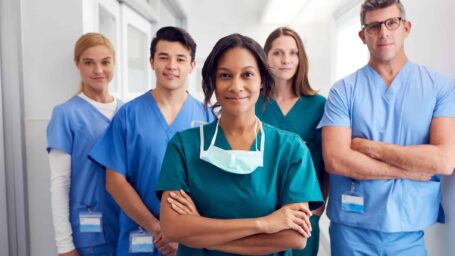 Portrait Of Multi-Cultural Medical Team Standing In Hospital Corridor
